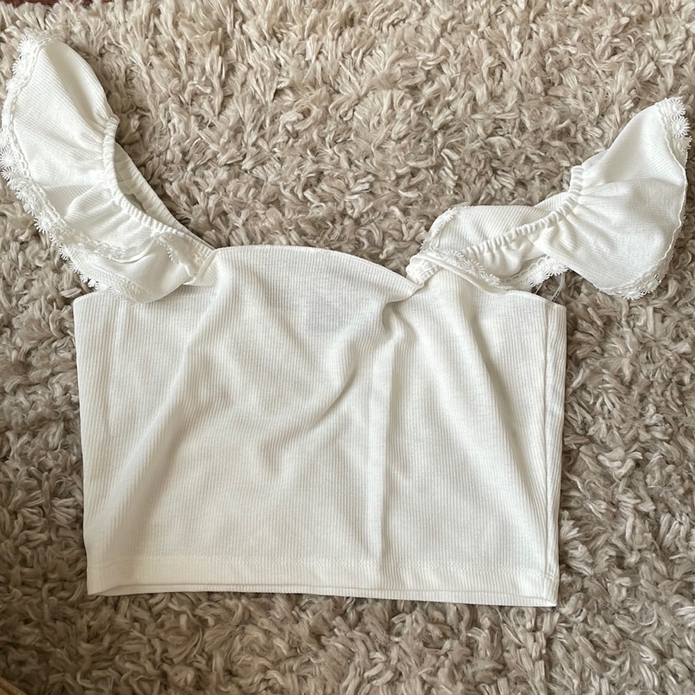 Shein white top with ruffle sleeves.